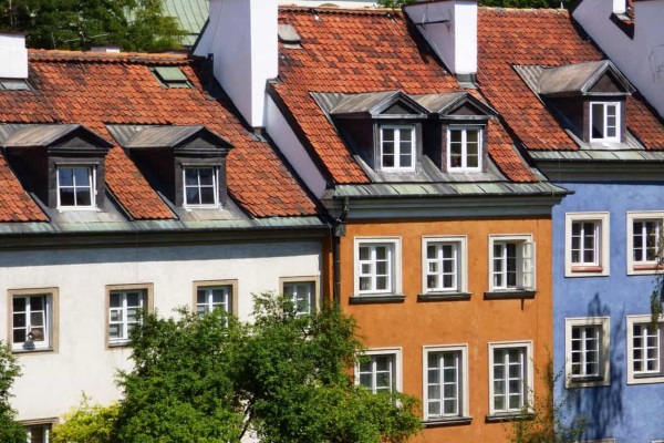 different colored shingles line up on residential roofs