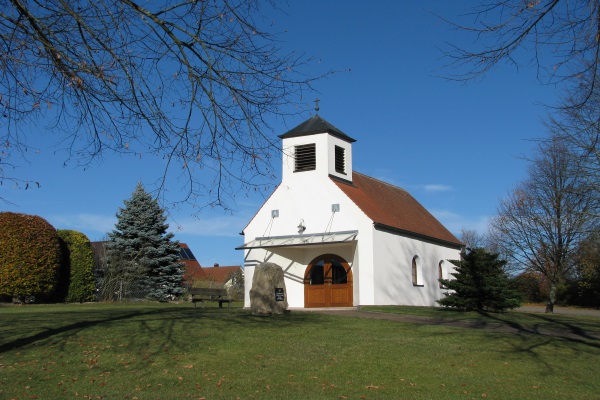 a church with a hip roof and belfry